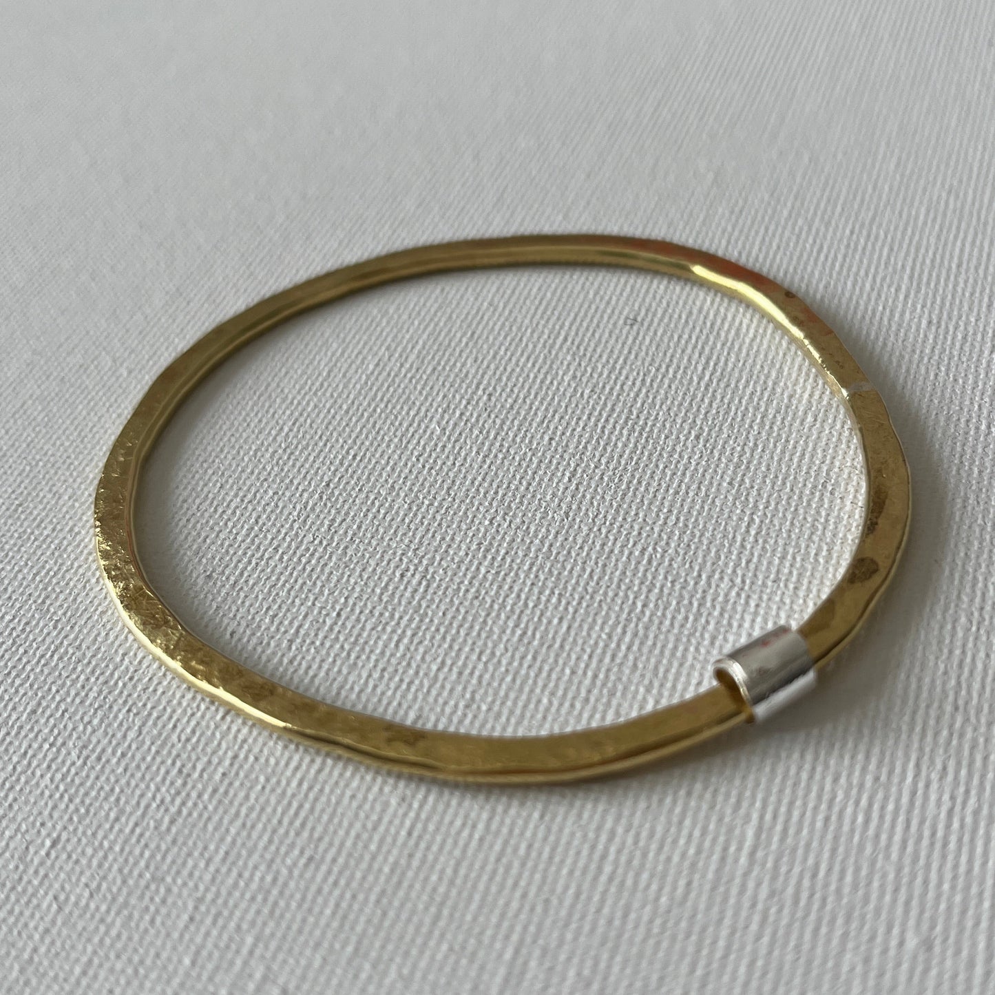 Hammered Brass Bangle with Silver Ripcurl Charm