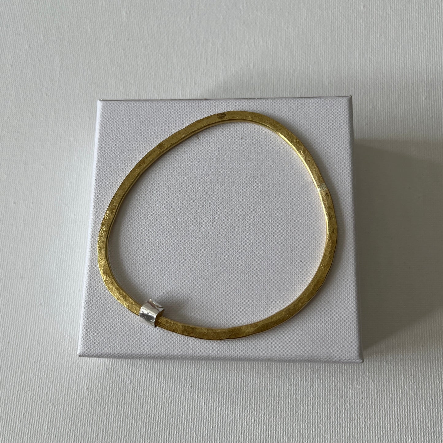 Hammered Brass Bangle with Silver Ripcurl Charm